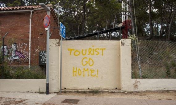 Un grafiti contra los turistas en el Turó de la Rovira / HUGO FERNÁNDEZ