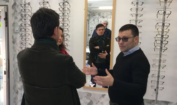 Manuel Valls dialogando con el propietario de una óptica en Ciutat Meridiana / PABLO ALEGRE