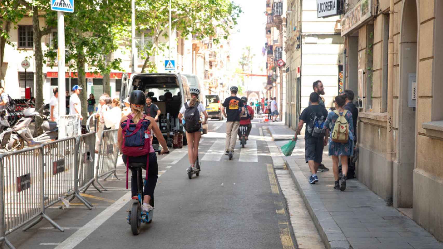 Varios usuarios de vehículos eléctricos paseando por una calle de Barcelona /  GU