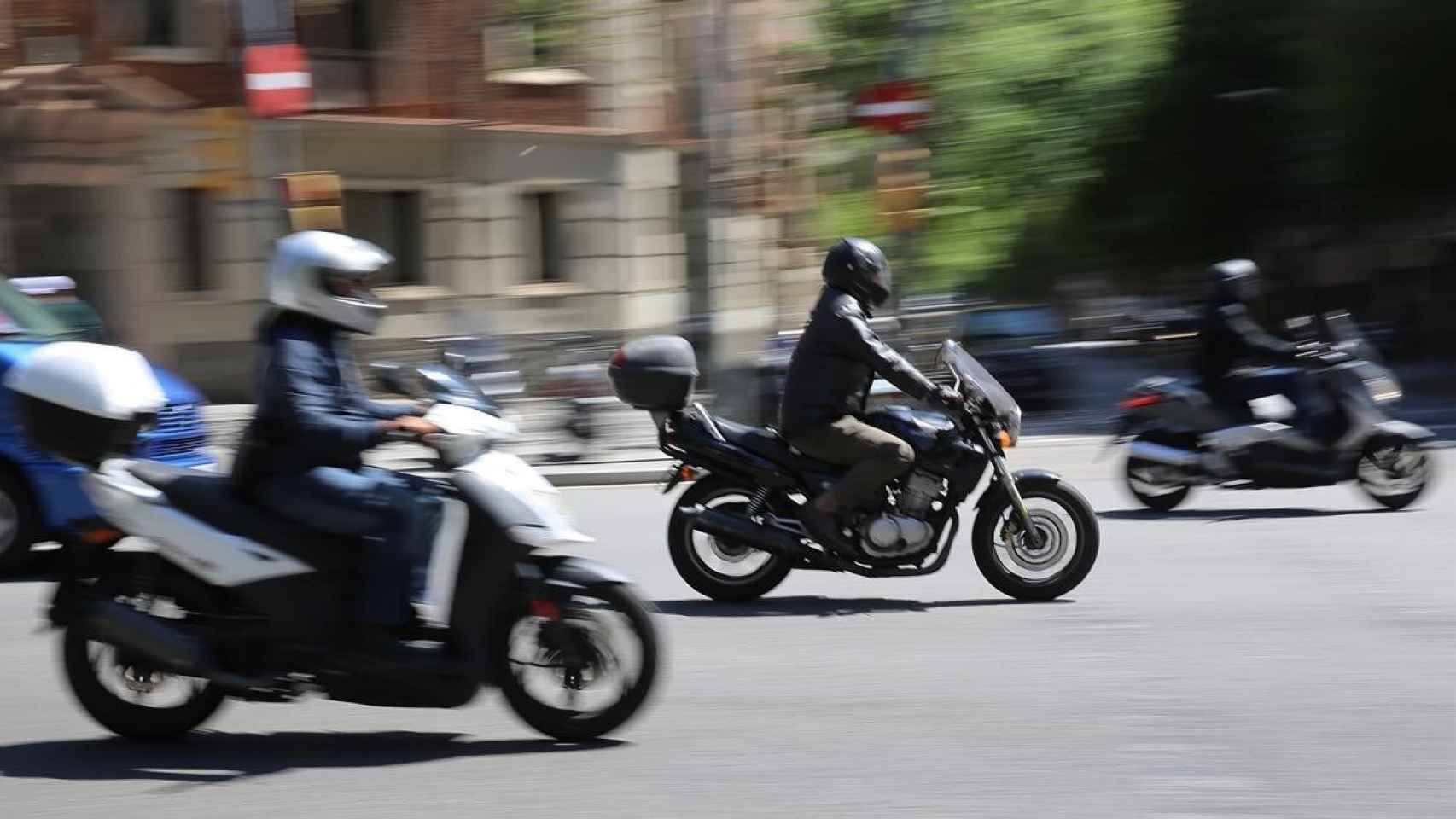 Tres motos conduciendo a gran velocidad por el centro de la ciudad