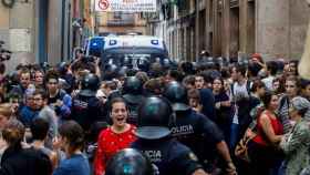 Efectivos de los Mossos d’Esquadra cargan contra varios activistas concentrados para impedir un desahucio en la calle de Sant Bartomeu, en el barrio del Raval, este jueves en Barcelona. EFE/