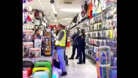 Agentes de la Guardia Urbana en el interior de uno de los comercios inspeccionados por productos falsificados / GUARDIA URBANA