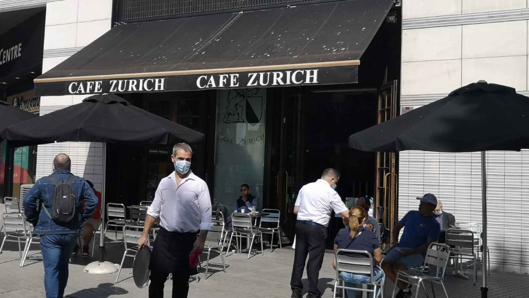 Dos camareros del Café Zurich trabajan esta mañana en la terraza del negocio en la plaça Catalunya / G.A