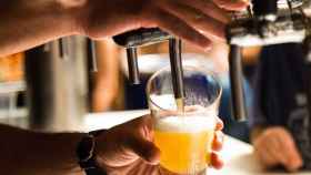 Un camarero sirviendo una cerveza en un bar