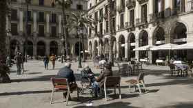 Adultos mayores toman el sol a medio día en la Plaza Reial / PABLO MIRANZO (MA)