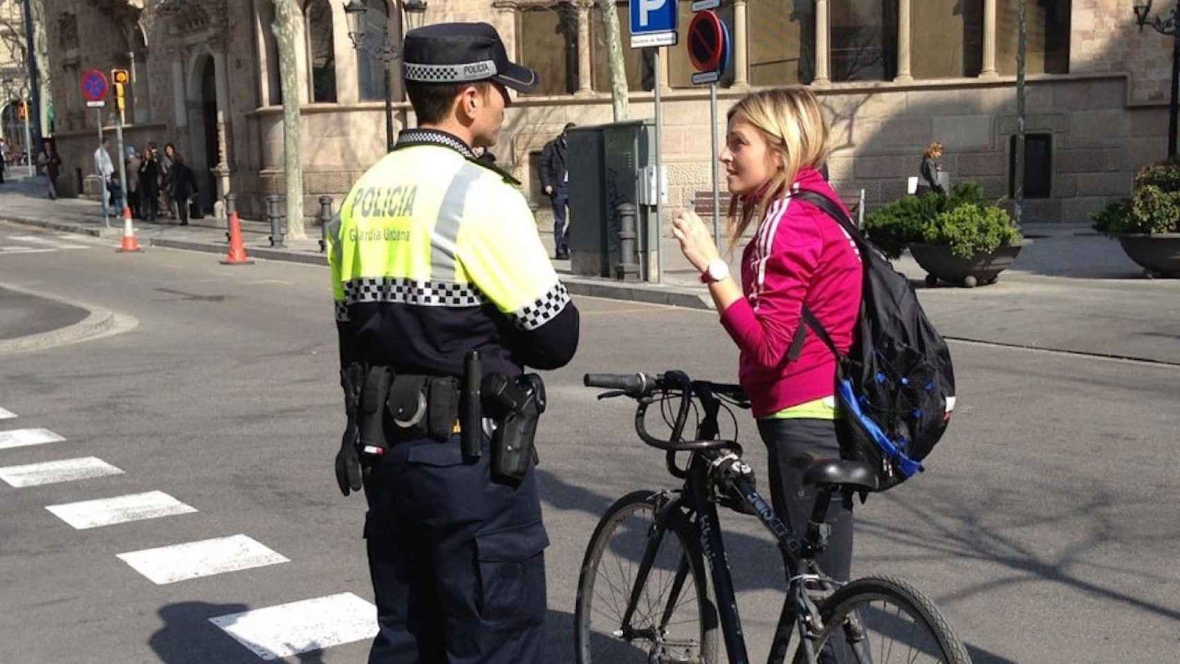 Un agente de la Guardia Urbana con una ciclista en Barcelona / AYUNTAMIENTO DE BARCELONA