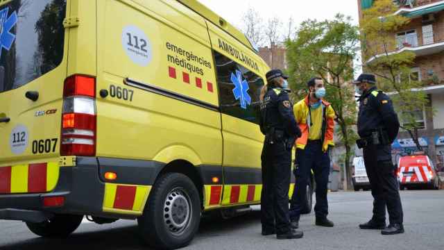 Agentes de la Guardia Urbana con un trabajador del SEM / GUB