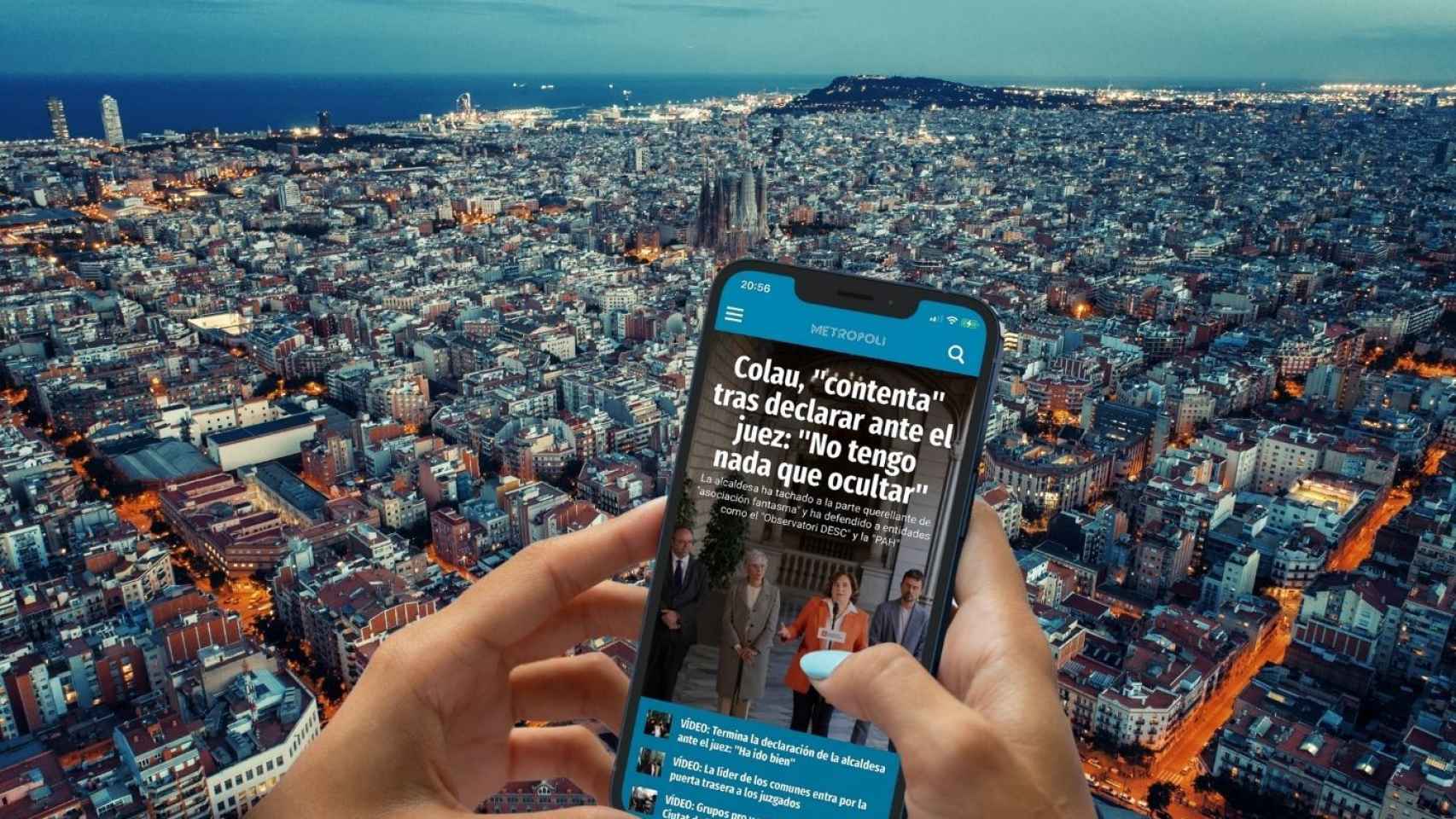 Fotomontaje con un móvil con la 'app' de Metrópoli y una imagen panorámica de Barcelona de fondo