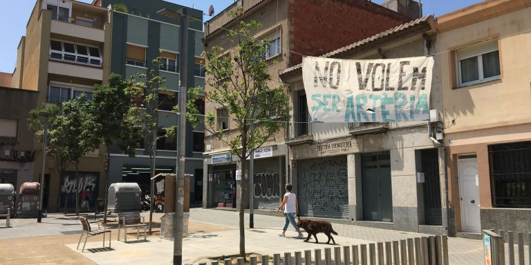 Pancarta contra el incremento del tráfico en la plaza de Marià Brossa / METRÓPOLI - RP