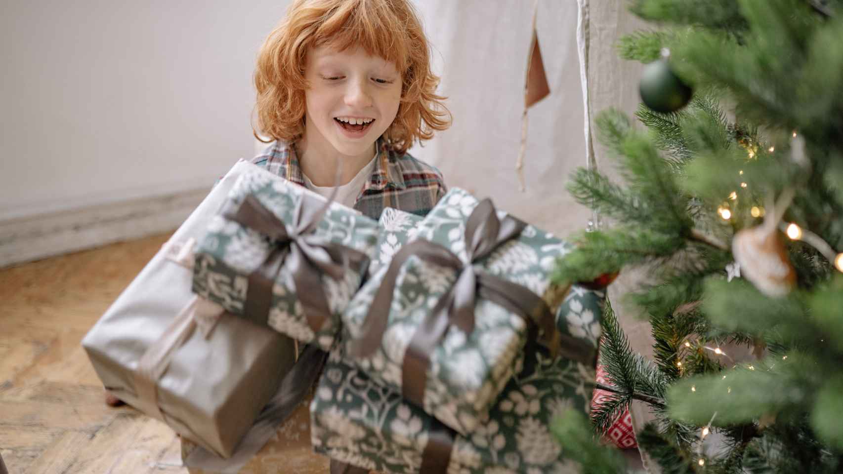 Un niño muestra su felicidad por los regalos de Navidad / PEXELS