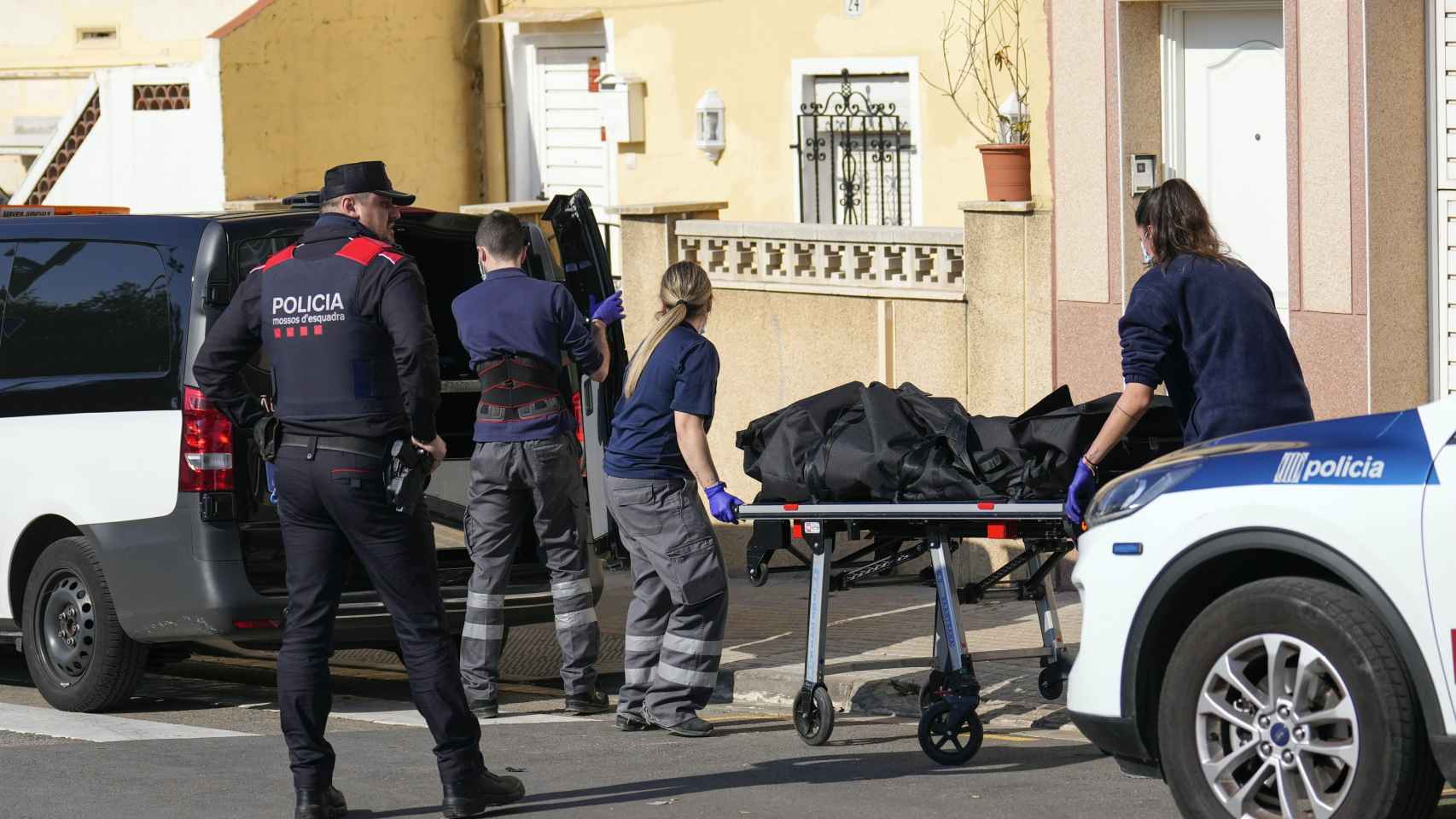 Personal de los servicios funerarios transportan el cadáver en Cornellà, presuntamente asesinado por su hermano / EFE-Alejandro García